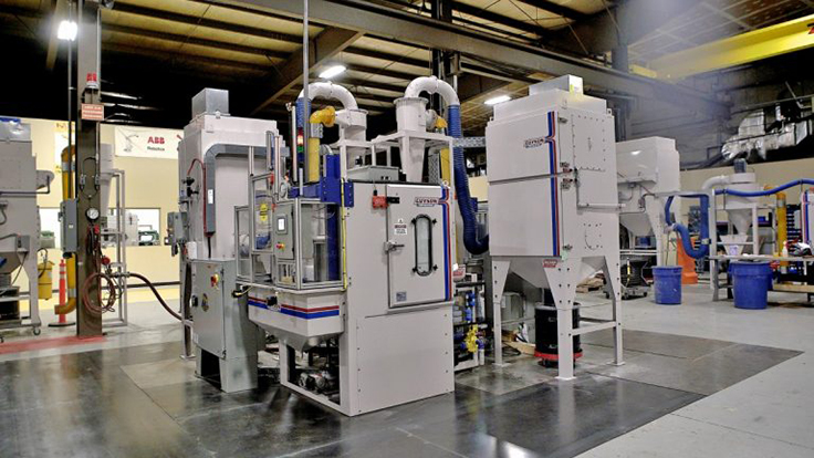 Twin spindle automated grit blasting machine for medical implants