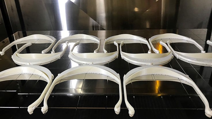 A tray of face shield visors being 3D printed by Stratasys. Thousands are now being produced by Stratasys or its coalition partners.