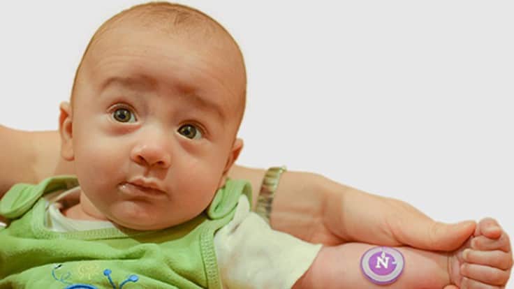 The comfortable new sweat sticker can conform to small newborns' arms and is gentle on their fragile skin. A healthy infant models the wearable device. 