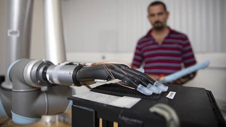 Researchers used individual fingertips fitted with stretchable tactile sensors with liquid metal on a prosthesis attached to a robotic arm.