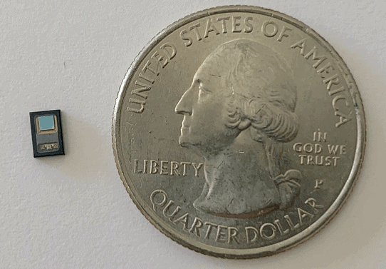 The state-of-the-art, ultra-miniaturized PPG sensor module compared to a quarter shows its small profile.