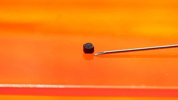 A jig for alignment and coupling of optical fibers (3mm x 3mm x 6mm) printed in ABS. The part has 100-micron holes where optical fibers are placed.