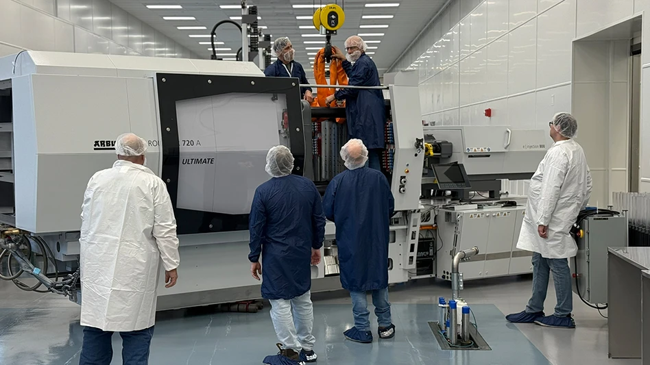 Plastikos Medical employees installing the new Arburg 720 injection molding press in it’s ISO-7 cleanroom