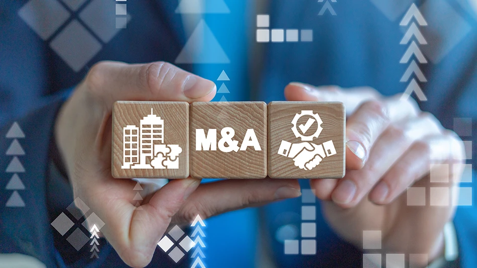 Hands holding wooden blocks with M&A stamped on them