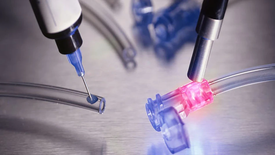 Application of adhesive materials to tubing