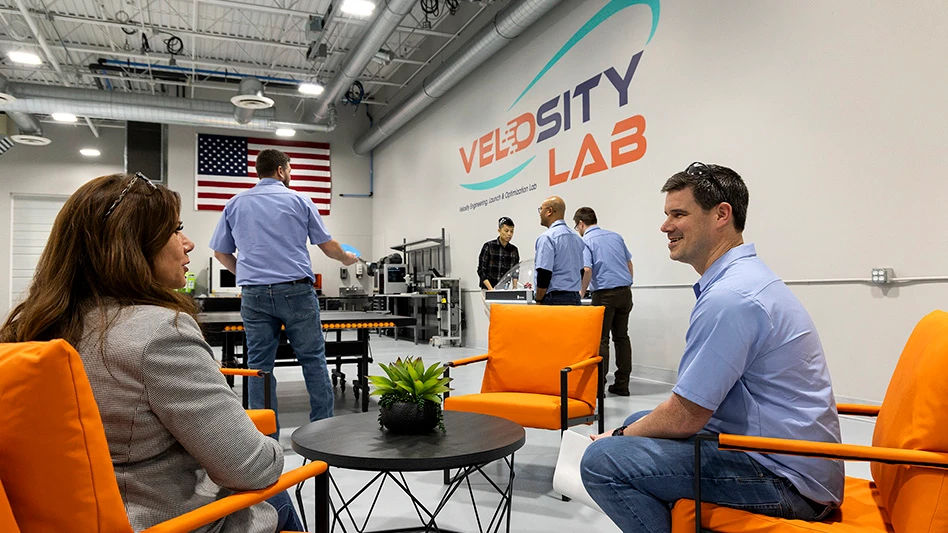 People sitting in orange chairs talking