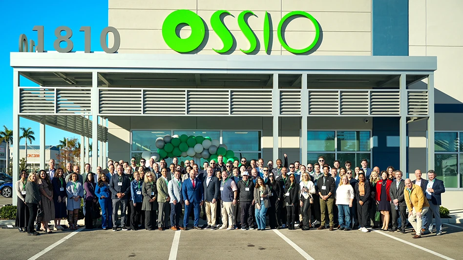 A group of people standing in front of an office