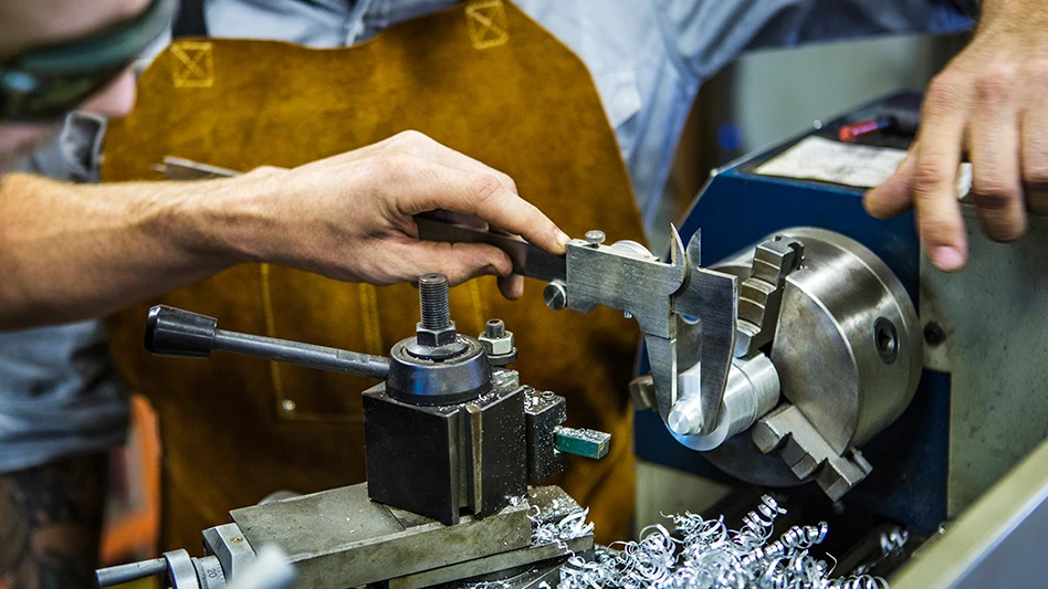 Machinists working on metal
